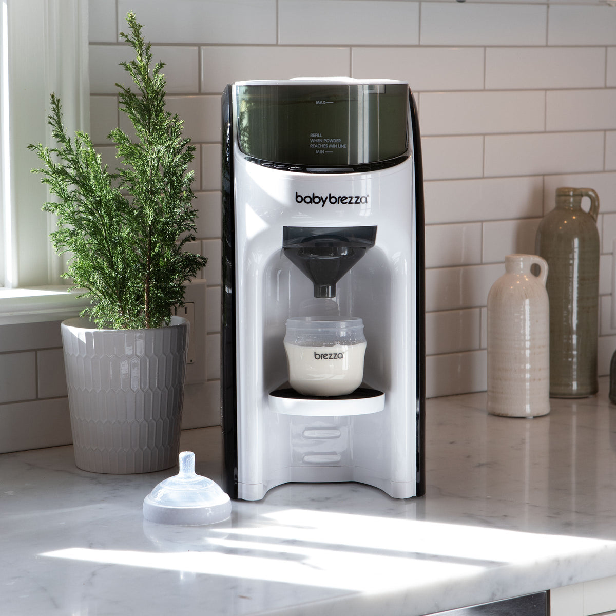 Baby formula maker next to potted plant #variant_white